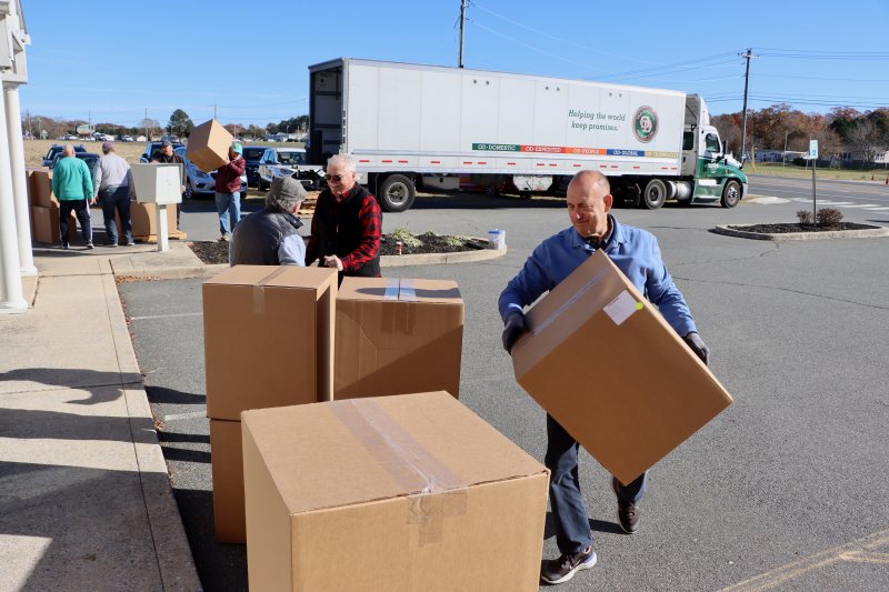 Jeff Tapkas, right, carries a box of sneakers at Clothing Our Kids’ Millsboro warehouse. The truck in the background delivered 1,000 pairs of brand-new sneakers Nov. 14. Clothing Our Kids received a grant from Shoes That Fit, a nonprofit in California. The shoes will be distributed to students in need from pre-K to high school at Sussex County schools. BILL SHULL PHOTOS